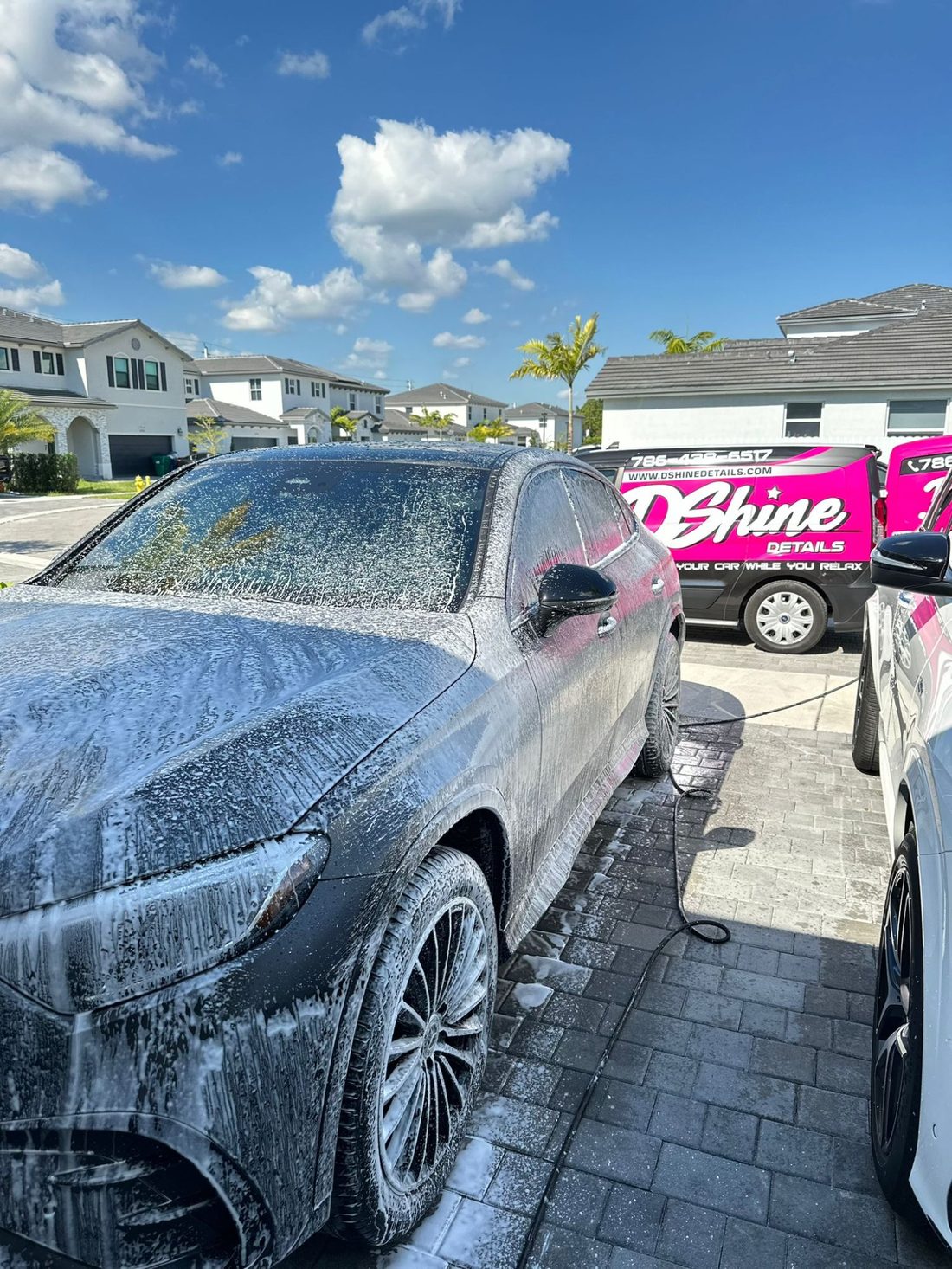 IDA certified technician steam-cleaning a vehicle interior during a Premium Detail in South Florida